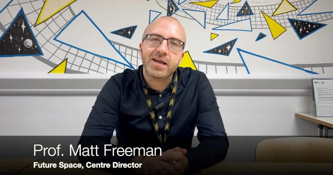 Matt Freeman sat at a desk