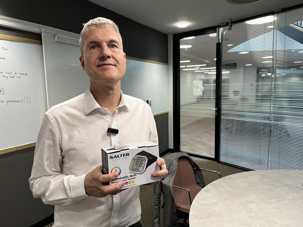 Paul Watson, National Innovation Centre for Data, holding a blood pressure monitor